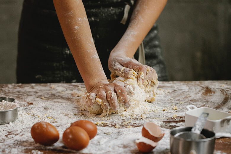 manos amasando masa de pan artesanal