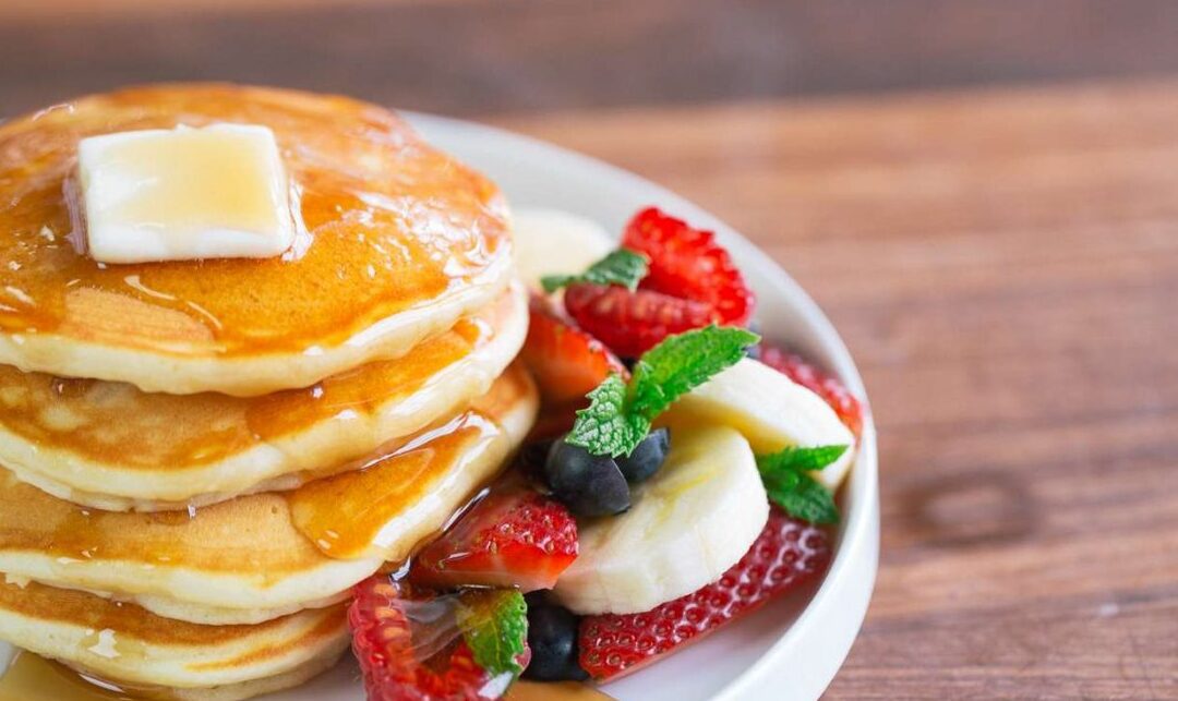 panqueques dulces con frutas y miel dorada