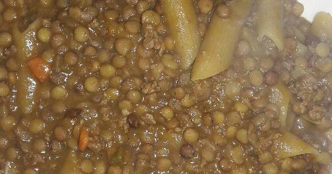 un plato de guiso de lentejas con carne picada